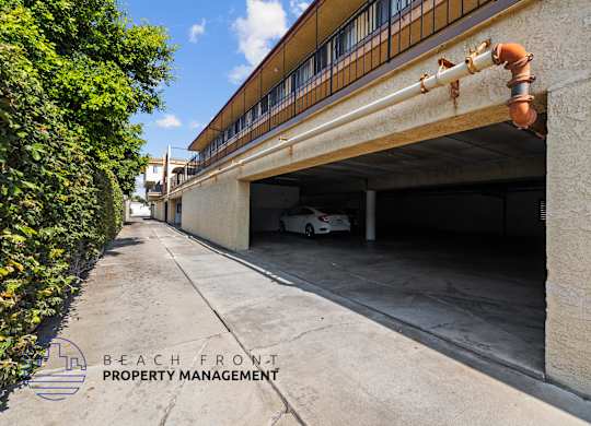 a white car is parked under a parking garage