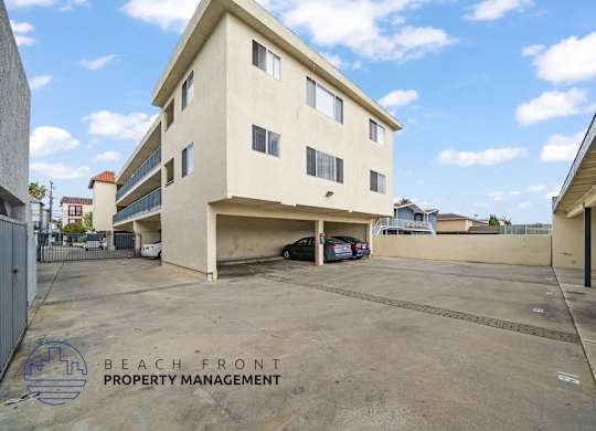 A building with a parking lot in front of it.
