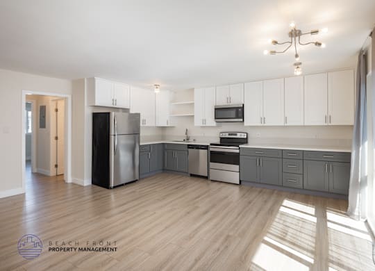 A kitchen with wooden floors and white walls.