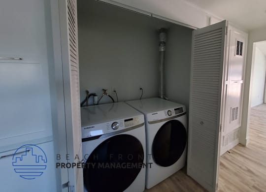 a washer and dryer in a laundry room with a closet