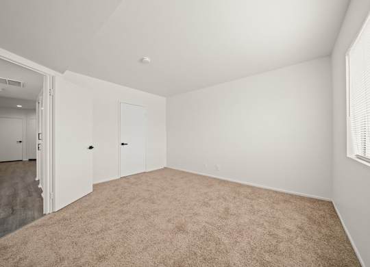 A room with carpeted floor and white walls.