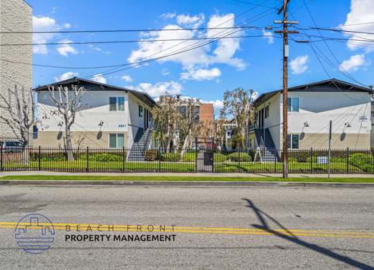 a street view of a row of houses on the side of a street