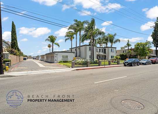 A street view with the logo of Beach Front Property Management.