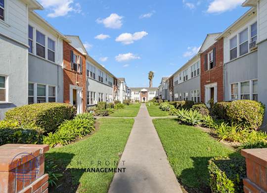 A row of houses with a pathway in the middle.