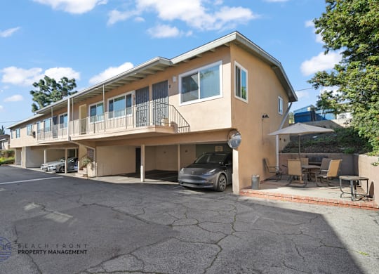 A two-story building with a balcony on the second floor.
