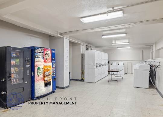 A vending machine selling Mountain Dew is in a large, empty room.