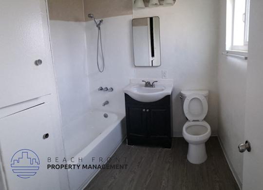 a bathroom with a toilet and a sink and a bath tub