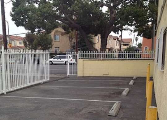 A white car is parked in a parking lot.