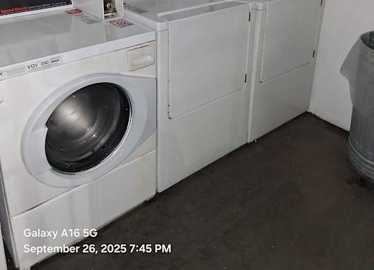 A washing machine with a control panel and a digital display.