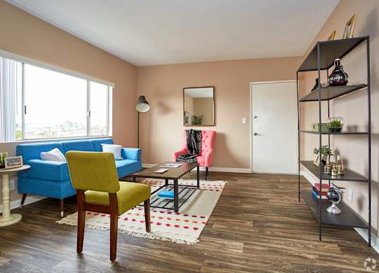 a living room with a blue couch and yellow chair