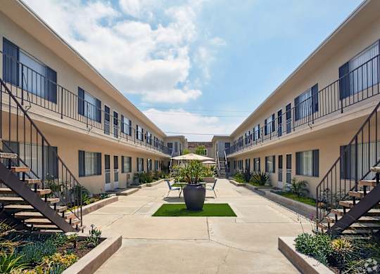 a courtyard with a large vase in the middle of it