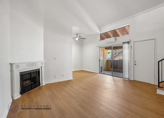A living room with a fireplace and a wooden floor.