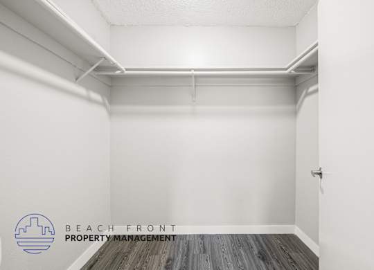 A white room with a logo for Beach Front Property Management.