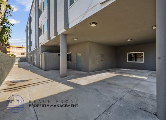 A parking garage with a logo for Beach Front Property Management.
