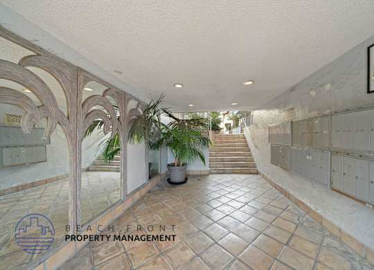 a view of the lobby of a building with tile floors and a staircase