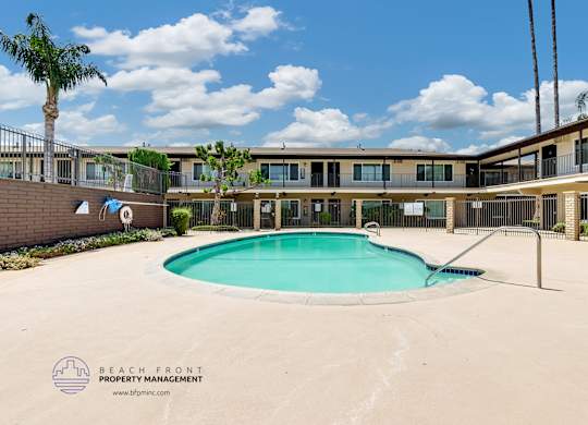 A pool in front of a building with the text