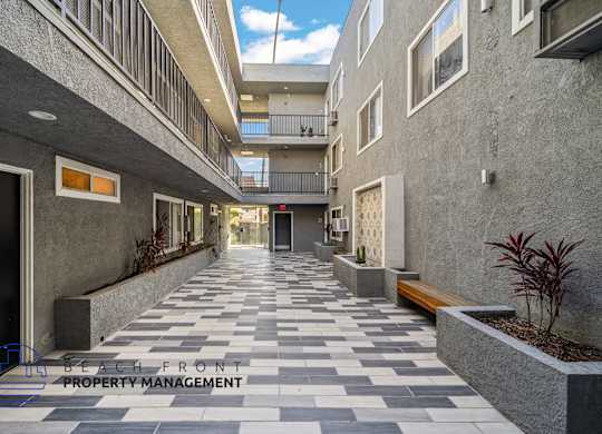 A long hallway with a tiled floor and concrete walls.