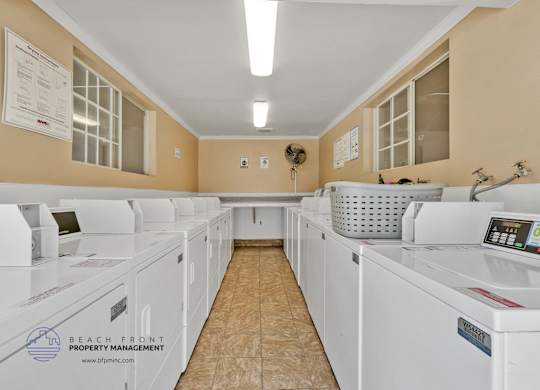 A row of washing machines in a laundromat.
