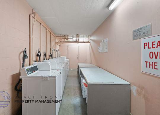 a laundry room with several washes and dryers in it