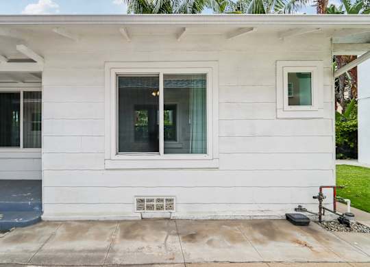 A white house with a window and a door.
