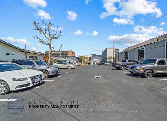a parking lot filled with cars in front of a building