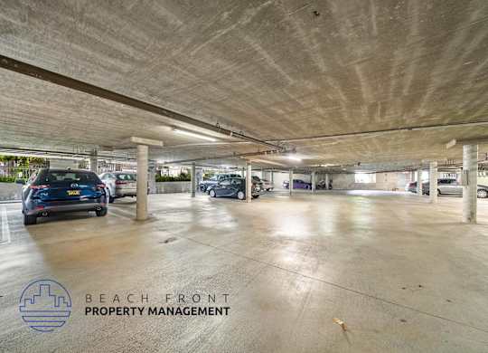 an empty parking garage with cars in it