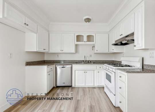 A kitchen with white cabinets and a stainless steel dishwasher.