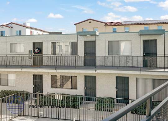 A building with a balcony and a sign that says Property Management.