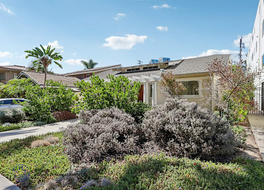 A house with a well-maintained garden in front.