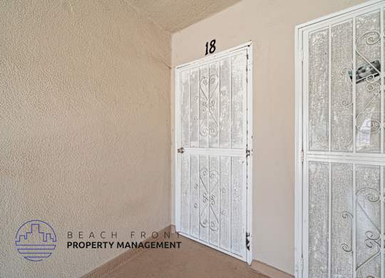 A white door with a glass window is closed.