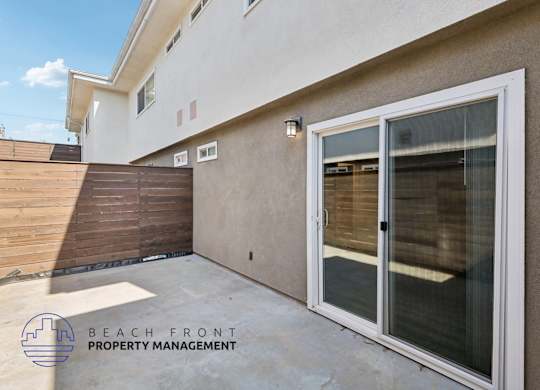 A balcony with a sliding door and a glass window is shown.