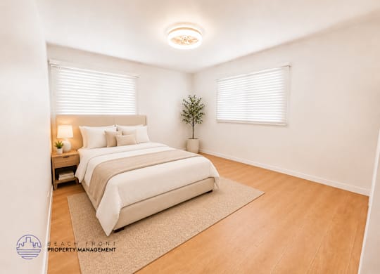 A bedroom with a bed, nightstand, and a plant.