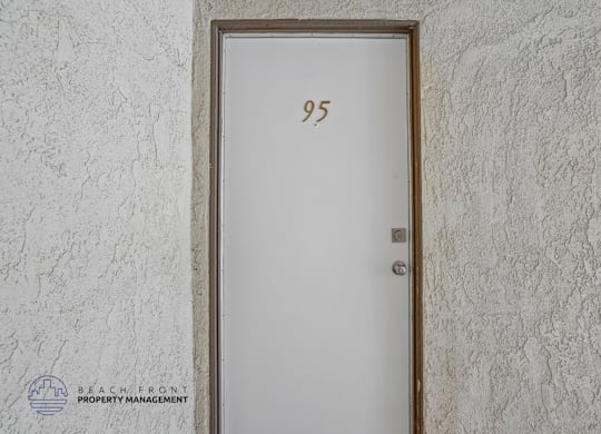 A door with the number 95 on it is set into a wall.