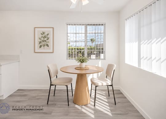 A dining room with a round table and chairs.