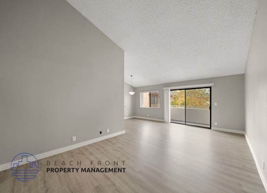 the renovated living room and dining room with wood flooring