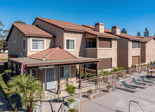 A sunny day at a residential complex with a clear blue sky.