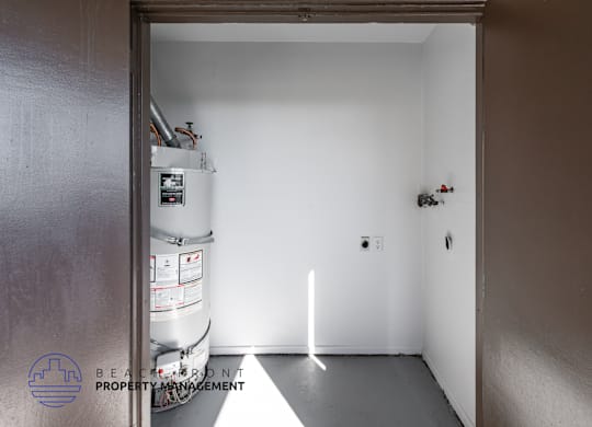 A white room with a doorway leading to another room.