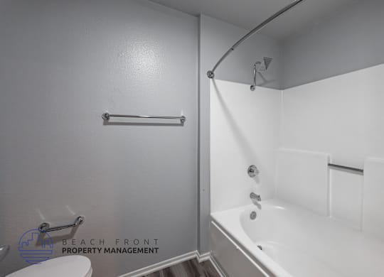 A white bathroom with a shower and a bathtub.