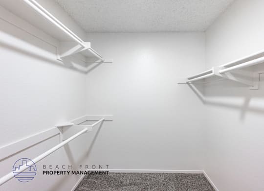 A white hallway with a logo for Beach Front Property Management.