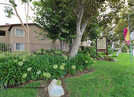 A sign for Barton Place is in front of a building.