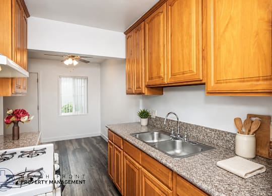 A kitchen with wooden cabinets and a granite countertop.