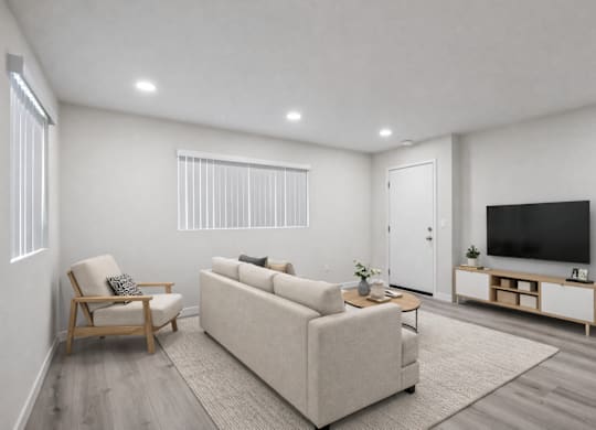 A living room with a couch, chair, and television.