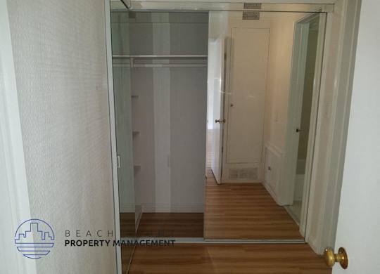 a glass door in a hallway leading to a closet