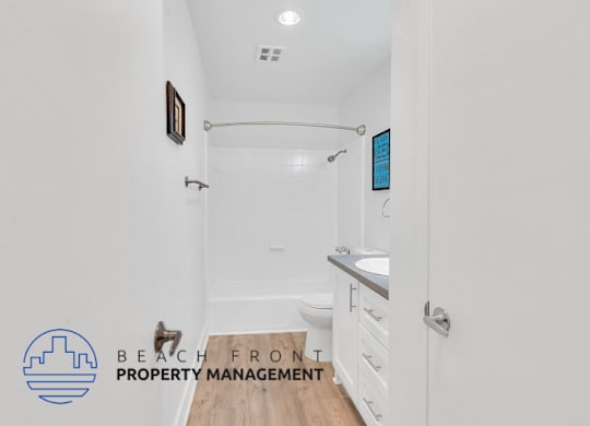 a bathroom with a shower and a sink and a toilet