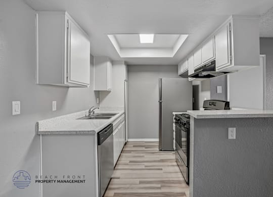 A kitchen with a dishwasher, sink, and stove.
