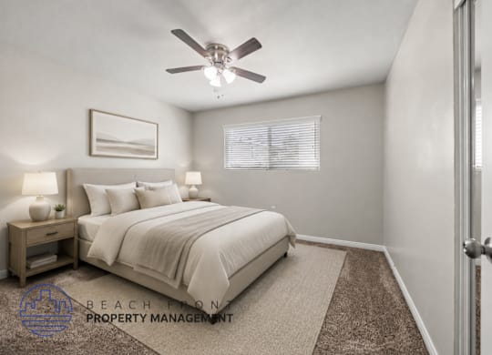 A well-lit bedroom with a large bed and a ceiling fan.