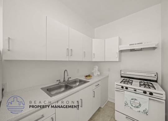 A kitchen with a stove and sink.