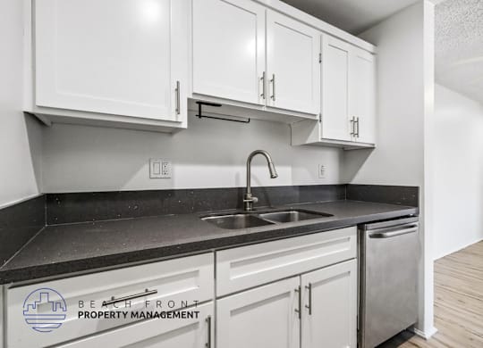 A kitchen with a sink and cabinets.
