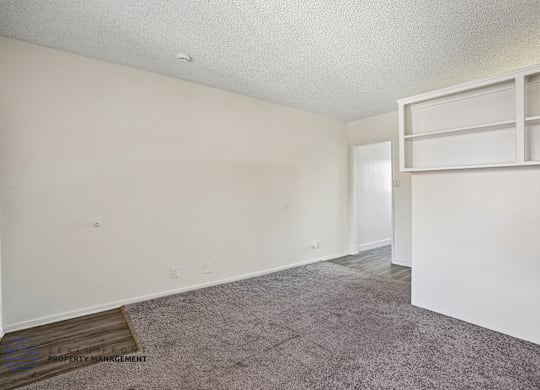 A room with a carpeted floor and white walls.