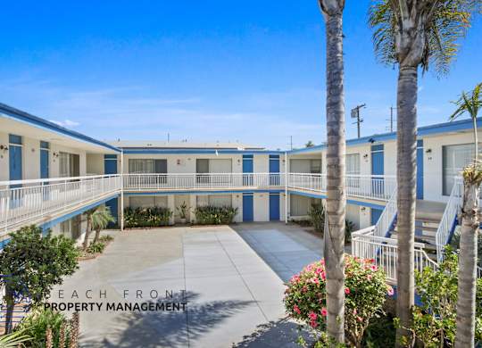 A beachfront property management building with blue and white exterior.